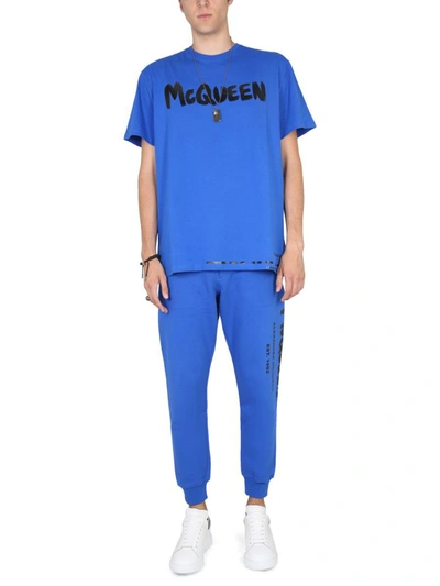 Shop Alexander Mcqueen Jogging Pants With Graffiti Logo In Blue