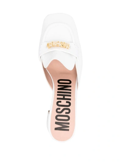 Shop Moschino Sandals In White