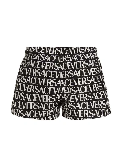 Shop Versace 'logomania' Swimming Trunks In White/black