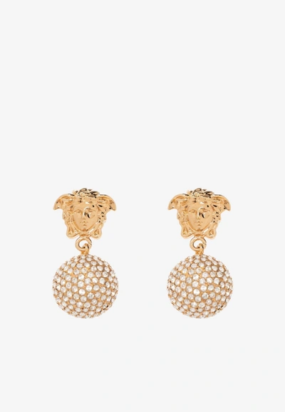Shop Versace Crystal Embellished Medusa Drop Earrings In Gold