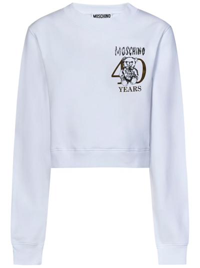 Shop Moschino Logo Printed Crewneck Cropped Sweatshirt In White