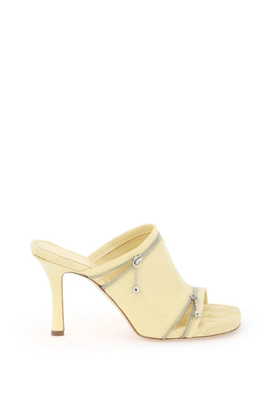 Shop Burberry Glossy Leather Peep Mules In Yellow