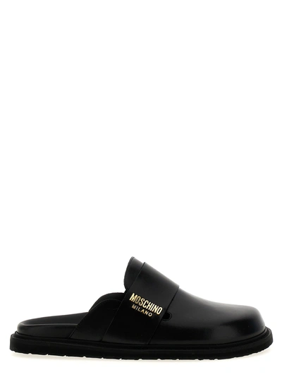 Shop Moschino Logo Sabots Flat Shoes Black