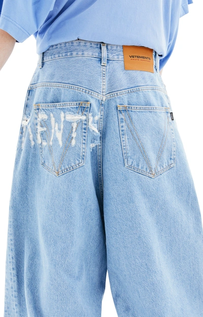 Shop Vetements Logo Destroyed Baggy Jeans In Light Blue