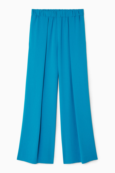 Shop Cos Pleated Elasticated Wide-leg Trousers In Turquoise