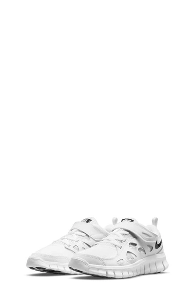 Shop Nike Kids' Free Run 2 Sneaker In White/ Black/ Wolf Grey