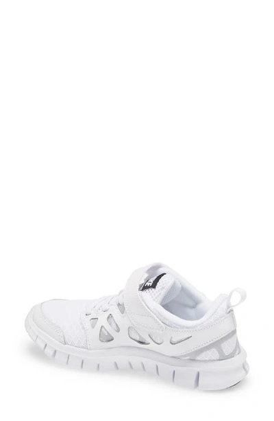 Shop Nike Kids' Free Run 2 Sneaker In White/ Black/ Wolf Grey
