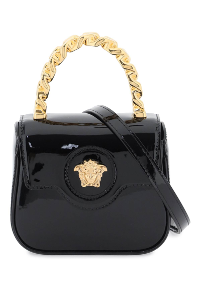 Shop Versace Patent Leather La Medusa Mini Bag In Black  Gold (black)