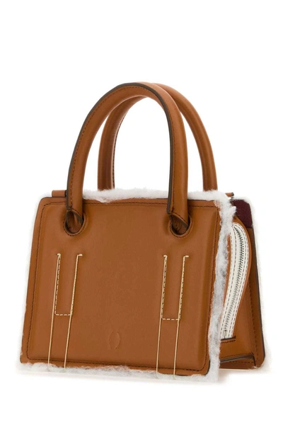 Shop Dentro Handbags. In Brown