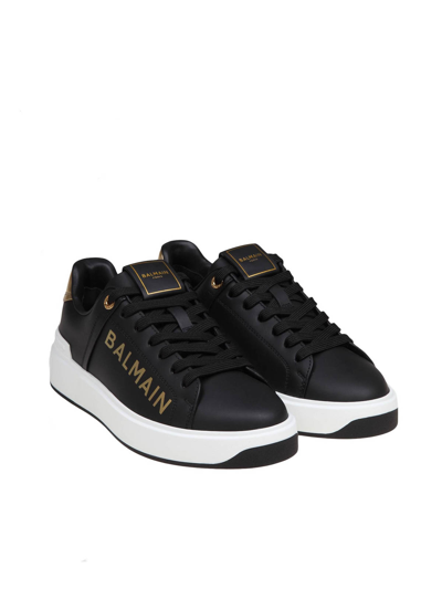 Shop Balmain B-court Sneakers In Black And Gold Leather