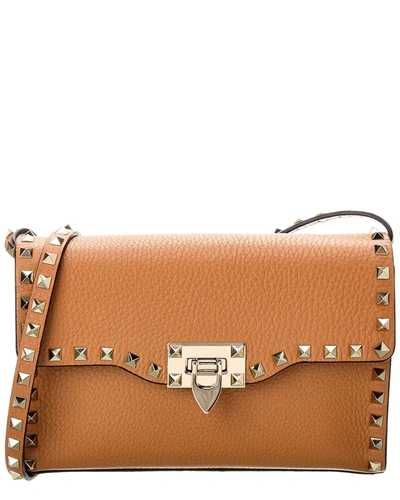 Shop Valentino Rockstud Small Grainy Leather Crossbody In Brown