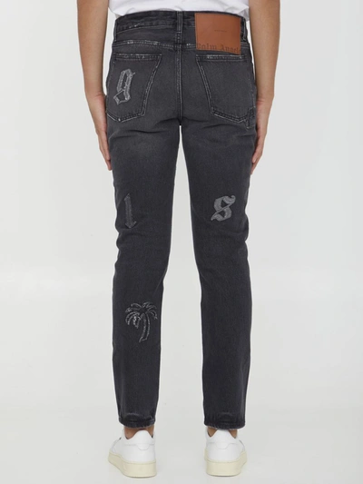 Shop Palm Angels Logo Patches Jeans In Black