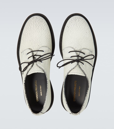 Shop Common Projects Cracked Leather Derby Shoes In White