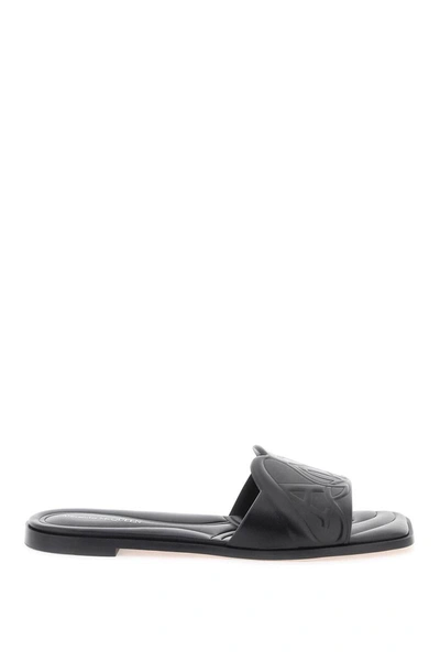 Shop Alexander Mcqueen Leather Slides With Embossed Seal Logo In Black