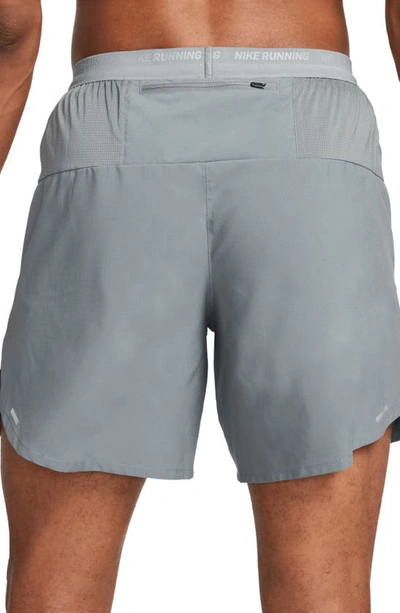 Shop Nike Dri-fit Stride Unlined Running Shorts In Smoke Grey/ Black