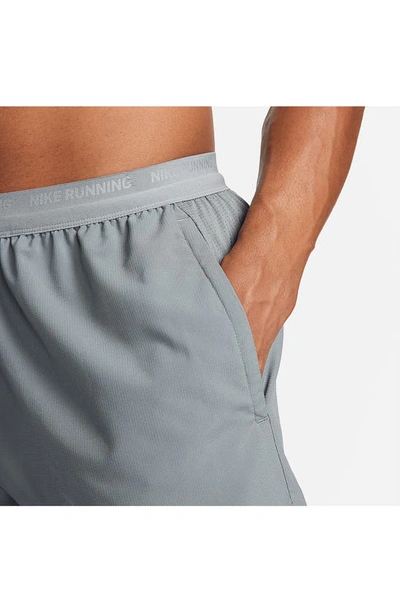 Shop Nike Dri-fit Stride Unlined Running Shorts In Smoke Grey/ Black