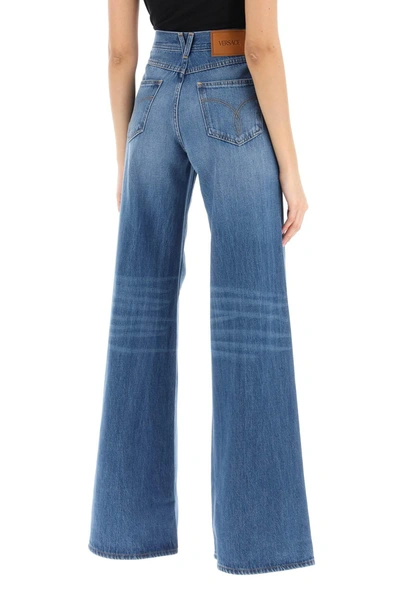 Shop Versace Flared Jeans With Medusa '95
