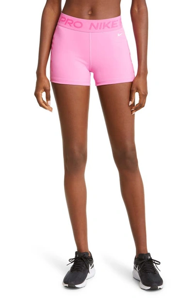 Shop Nike Pro Dri-fit Mid Rise Training Shorts In Playful Pink/ Pink/ White