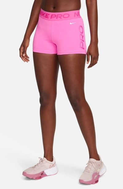 Shop Nike Pro Dri-fit Mid Rise Training Shorts In Playful Pink/ Pink/ White
