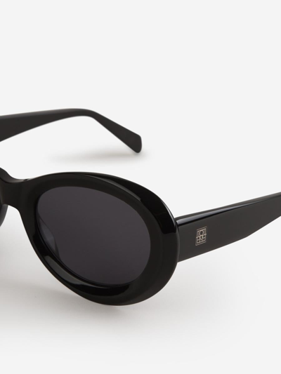 Shop Totême Oval Sunglasses In Black