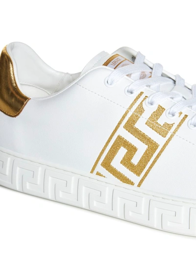 Shop Versace Greca Embroidered Sneakers In Golden