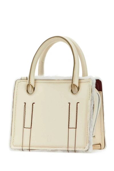 Shop Dentro Handbags. In White