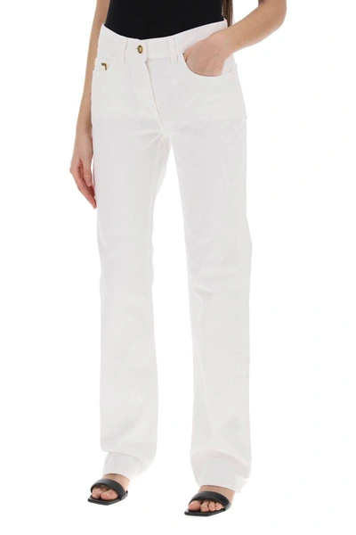 Shop Palm Angels Jeans With Gold Metal Detailing In White
