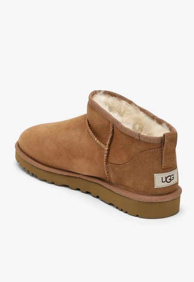 Shop Ugg Classic Ultra Mini Suede Boots In Beige