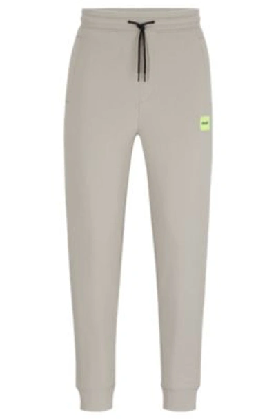 Hugo Boss Cotton-terry Tracksuit Bottoms With Red Logo Label In Light Grey