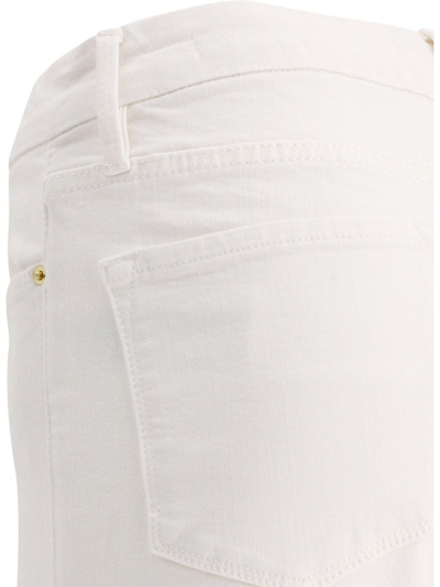 Shop Frame Low-rise Flared Jeans In Blanc Blanc