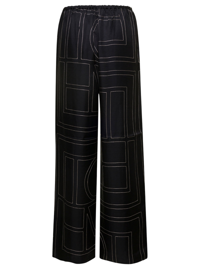 Shop Totême Black Loose Pants With Monogram Print In Silk Woman In Nero