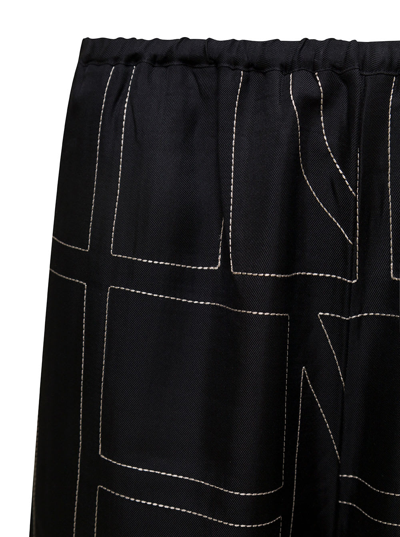 Shop Totême Black Loose Pants With Monogram Print In Silk Woman In Nero