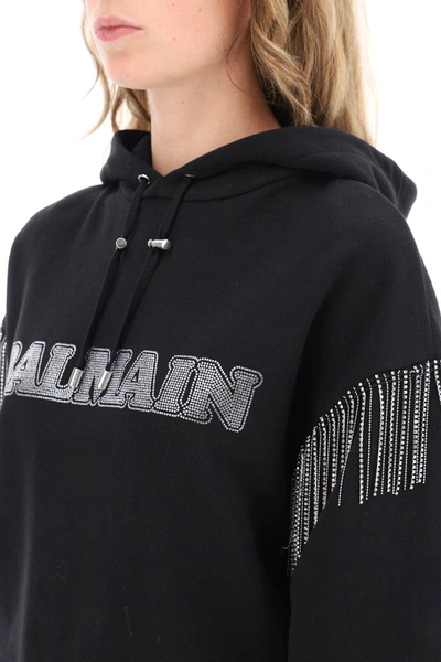 Shop Balmain Cropped Hoodie With Rhinestone-studded Logo And Crystal Cupchains In Black