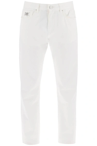 Shop Versace Medusa Regular Jeans In White