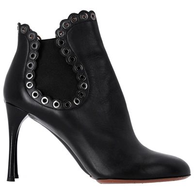 Shop Alaïa Eyelet Ankle Boots In Black Leather