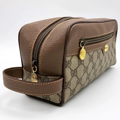 Shop Gucci Brown Canvas Clutch Bag ()