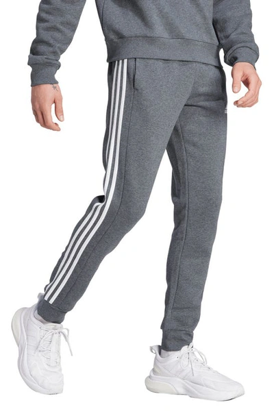 Shop Adidas Originals Adidas Essentials Fleece Tapered Joggers In Dark Grey Heather