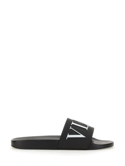 Shop Valentino Garavani Slide Sandal With Logo In Black