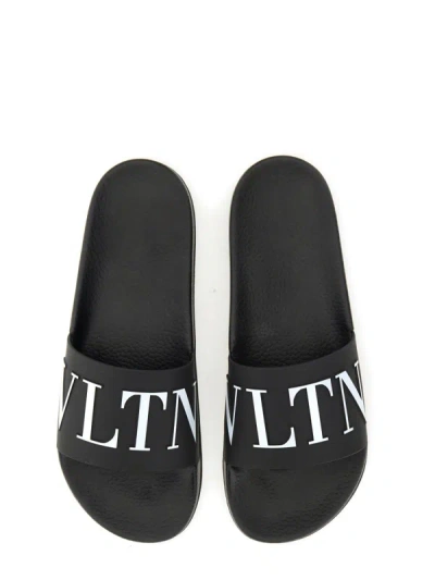 Shop Valentino Garavani Slide Sandal With Logo In Black
