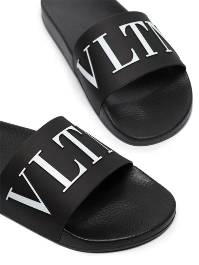 Shop Valentino Garavani Slide Sandal With Logo In Black