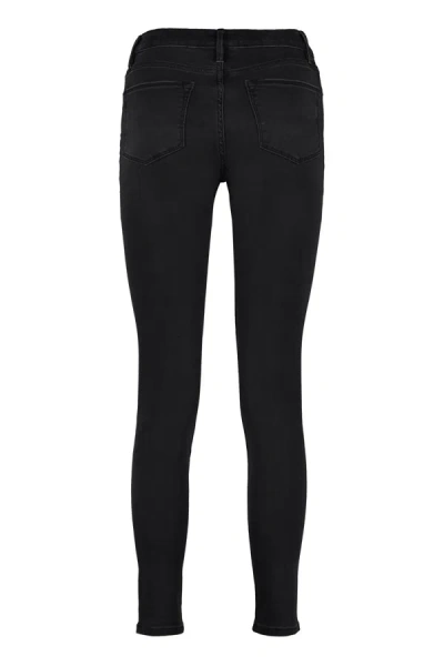 Shop Frame High-rise Skinny Jeans In Black