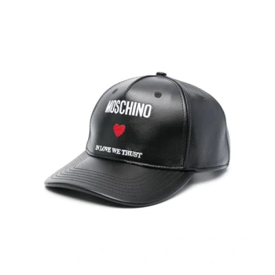 Shop Moschino Caps In Black
