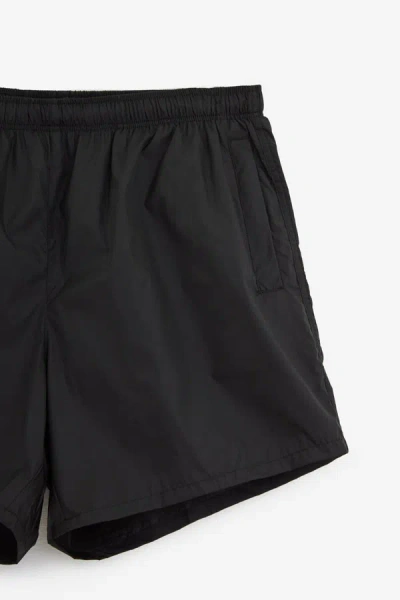 Our Legacy Elastic Waistband Swim Shorts With Side Pockets In Black