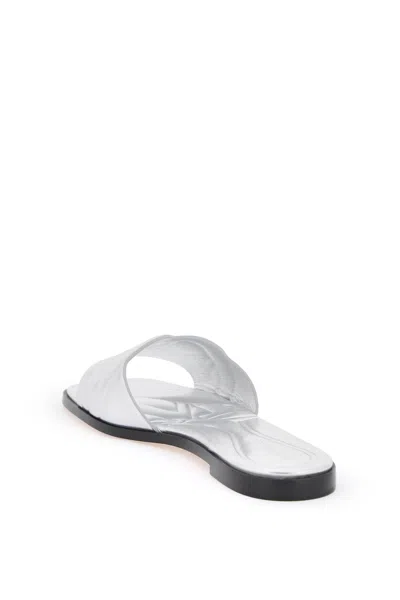 Shop Alexander Mcqueen Laminated Leather Slides With Embossed Seal Logo