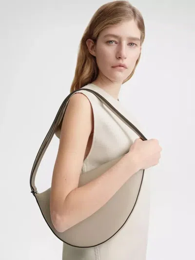 Shop Totême Scooped Sling Shoulder Bag In Beix