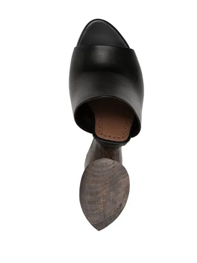 Shop Alaïa Sculpture Wedge Sandals In Black
