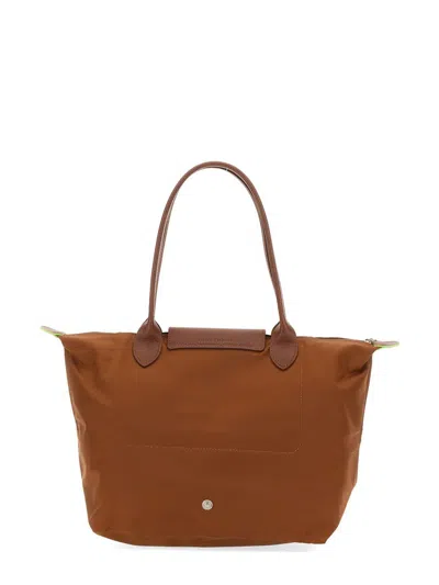 Shop Longchamp Le Pliage Bag In Buff