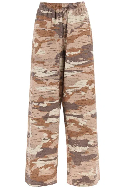 Shop Acne Studios Camouflage Jersey Pants For Men In Beige