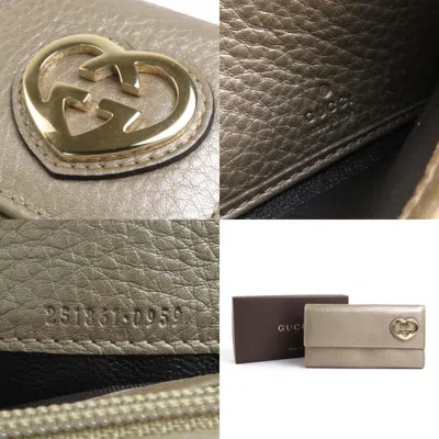 Shop Gucci Interlocking Gold Leather Wallet  ()