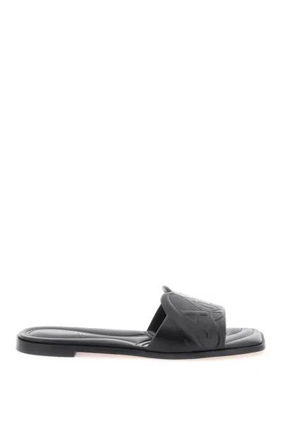 Shop Alexander Mcqueen Leather Slides With Embossed Seal Logo In Black